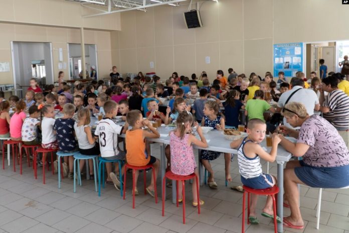 Children from different orphanages from the Donetsk region eat a meal at a camp in Zolotaya Kosa, southwestern Russia, Friday, July 8, 2022. (AP Photo)