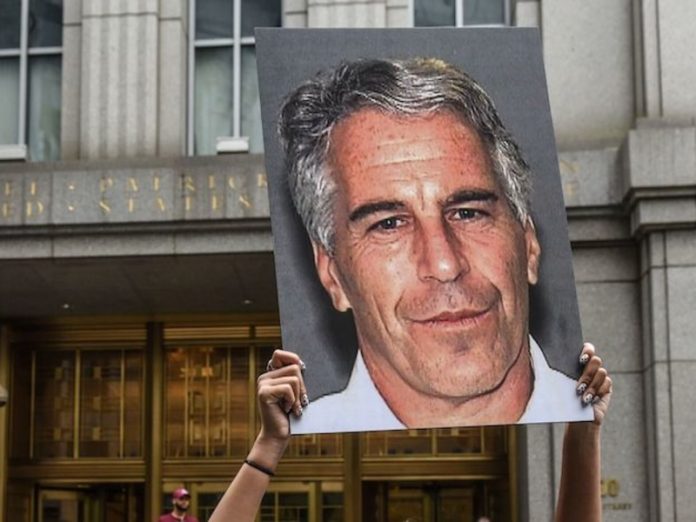 A protester holds up a sign of Jeffrey Epstein in front of the federal courthouse in New York on July 8, 2019. GETTY