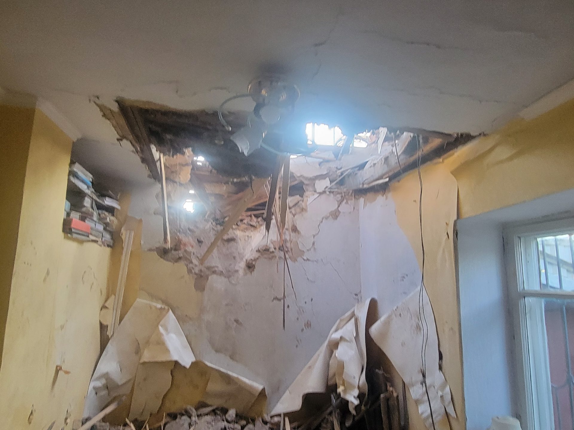 A hole in a residential home's ceiling caused by falling debris after a Russian missile was intercepted near Odessa. (Photo by Operational Command South)