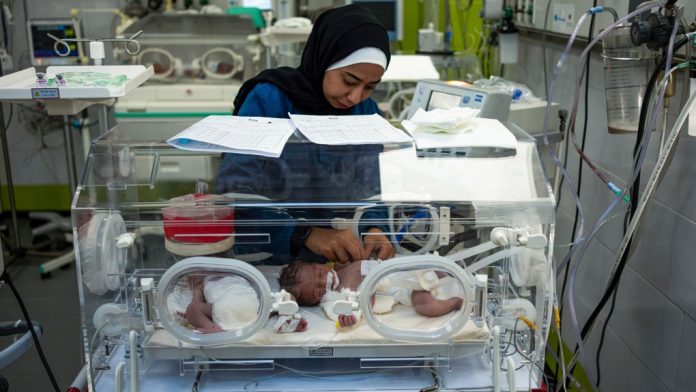 A nurse cares for babies at the premature ward of the Emirati Hospital in Rafah, in southern Gaza, on Friday, March 8. Sixteen premature babies have died of malnutrition-related causes over the past five weeks at the hospital. Fatima Shbair/AP