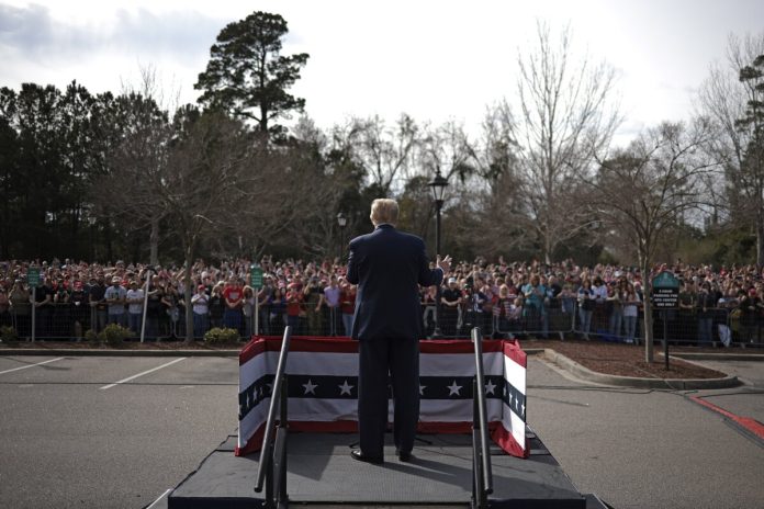 Feb. 10, 2024 | Supporters of Donald Trump listen while he speaks during a Get Out The Vote rally at Coastal Carolina University in Conway, South Carolina. (WIN MCNAMEE/GETTY IMAGES)